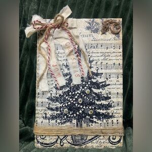 Music notes and Christmas tree decorated book.